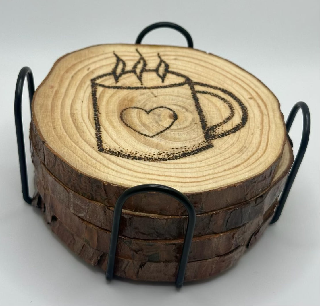 4 wooden disks stacked on top of each other. these disks sit inside a metal stand that encases them. The disk on top has a design of a coffee cup with a heart on it and some steam leaving the cup burned onto it.
